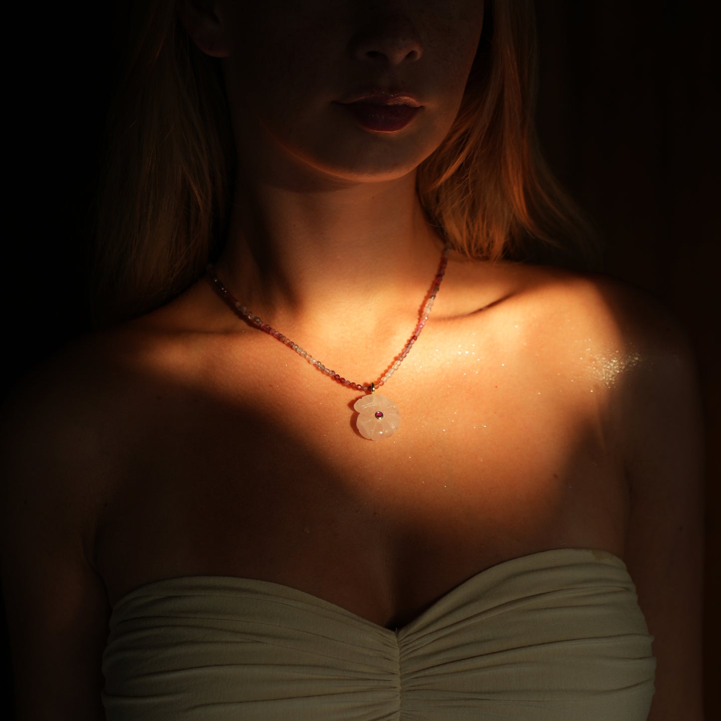 CONCHA necklace from After-Sun Hours, pink beaded strand with a carved rose quartz shell pendant.