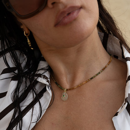NONI necklace from After-Sun Hours, beads shading from green to gold with a soft green pendant.