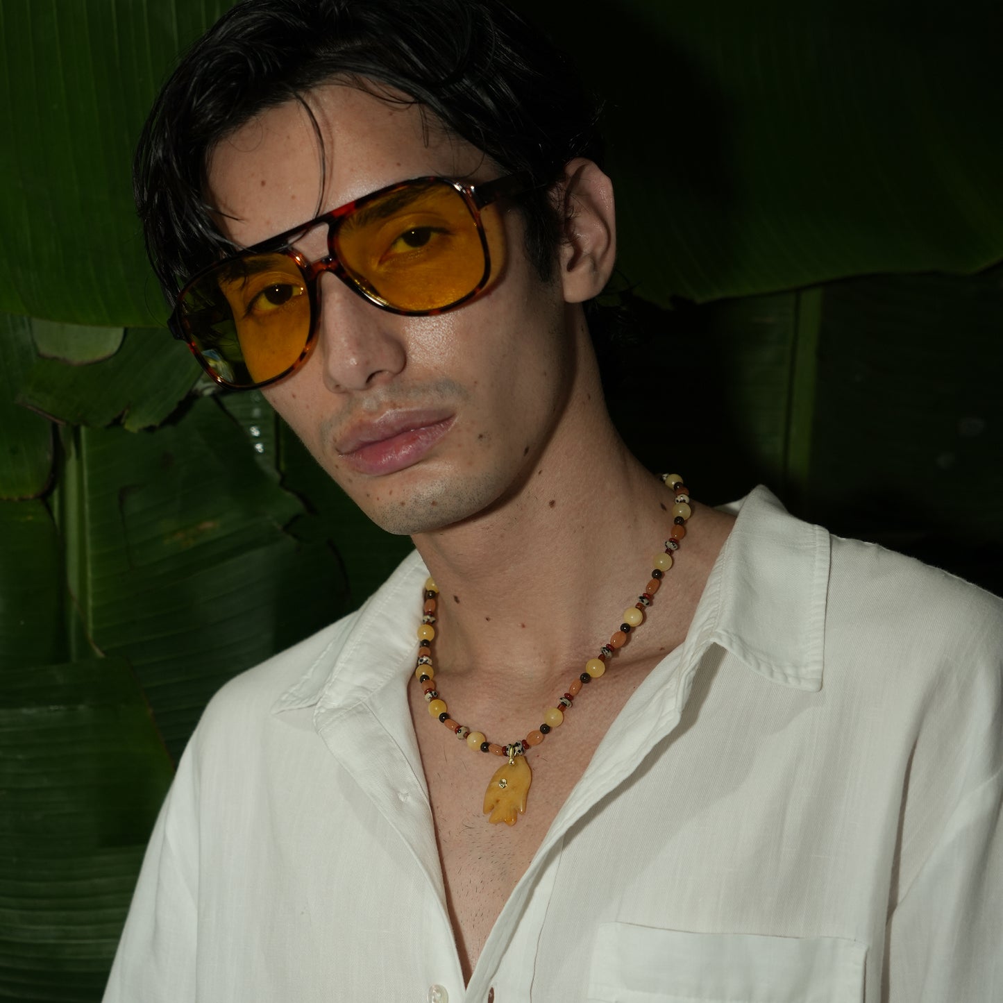 JUNO necklace from After-Sun Hours, honey and amber beaded strand with a carved fish pendant.