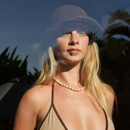 MABE necklace from After-Sun Hours, a strand of peach and pink pearls.