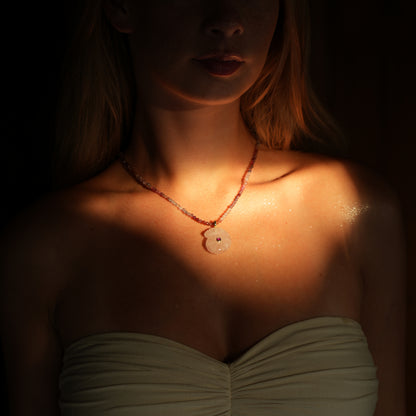 CONCHA necklace from After-Sun Hours, pink beaded strand with a carved rose quartz shell pendant.