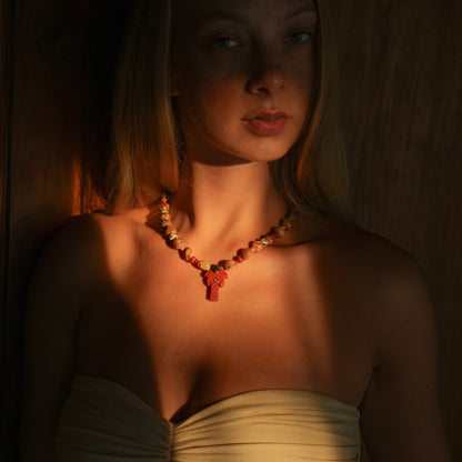 DALI necklace from After-Sun Hours, warm red and cream beaded strand with a carved red palm pendant.