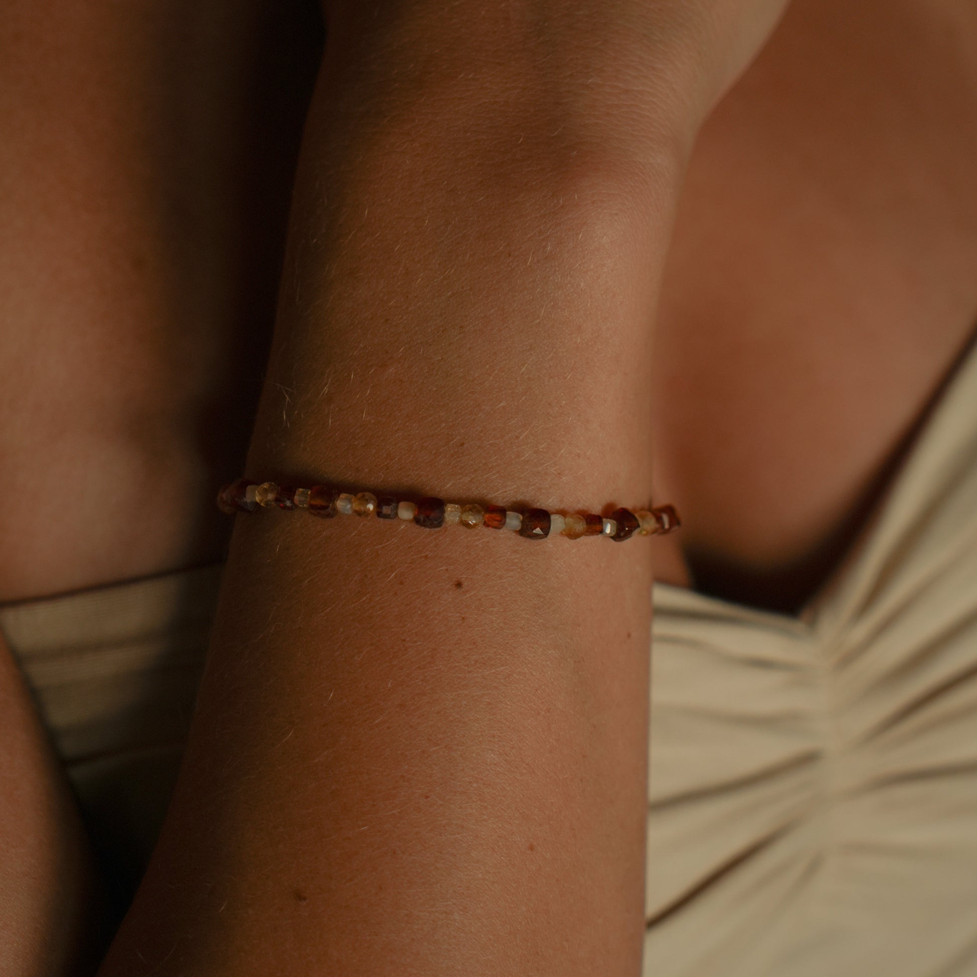 SUNA bracelet from After-Sun Hours, warm orange and pale yellow beads.
