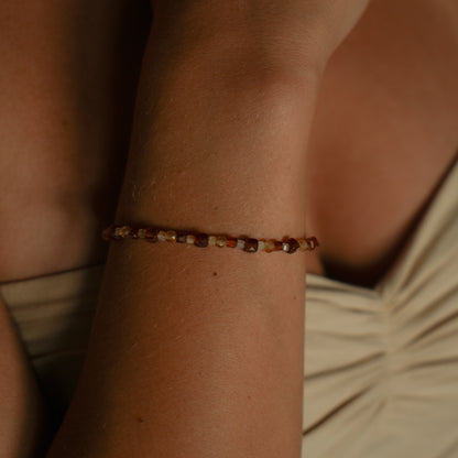 SUNA bracelet from After-Sun Hours, warm orange and pale yellow beads.