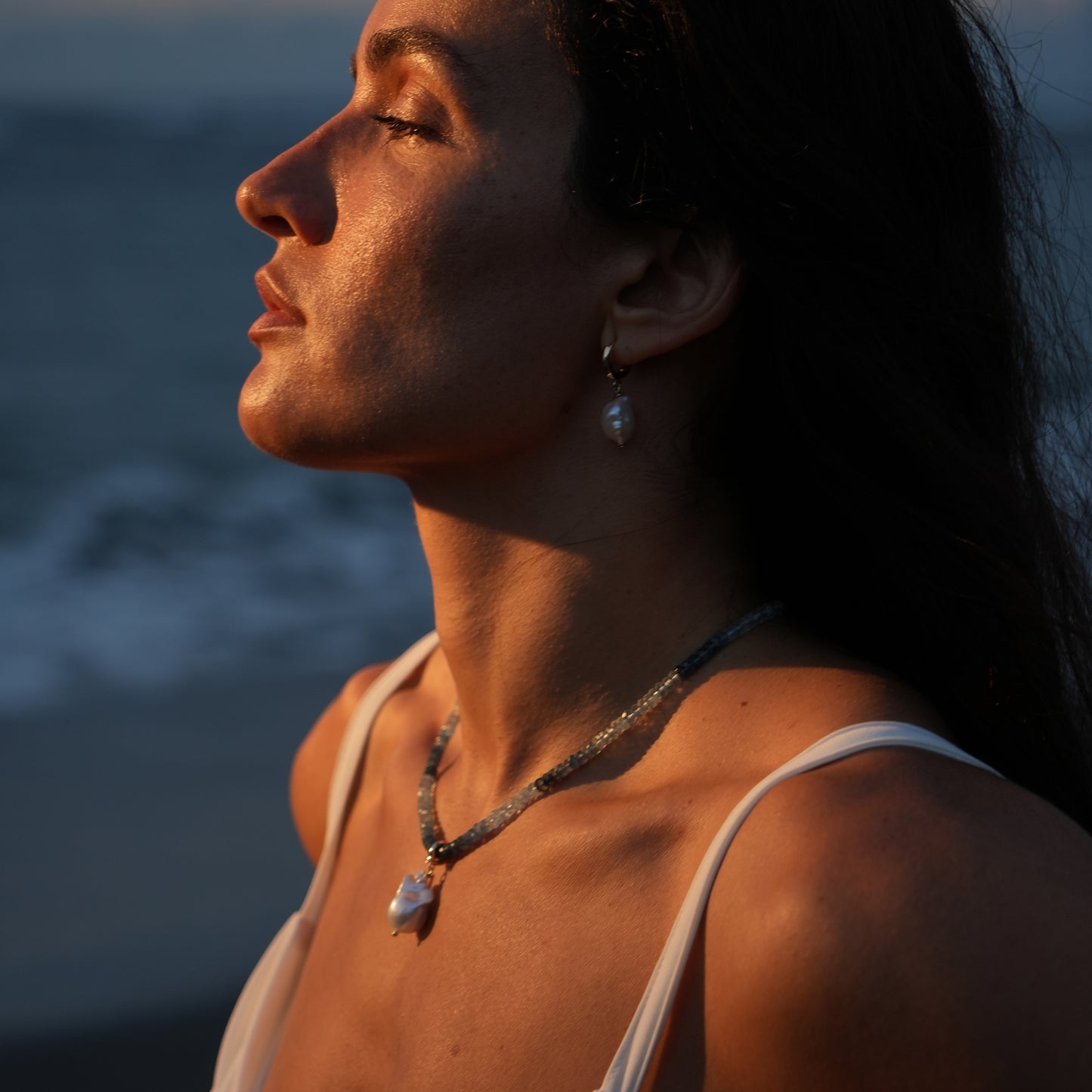 MAREA necklace from After-Sun Hours, a gradient of pale blue beads with a single pearl charm.