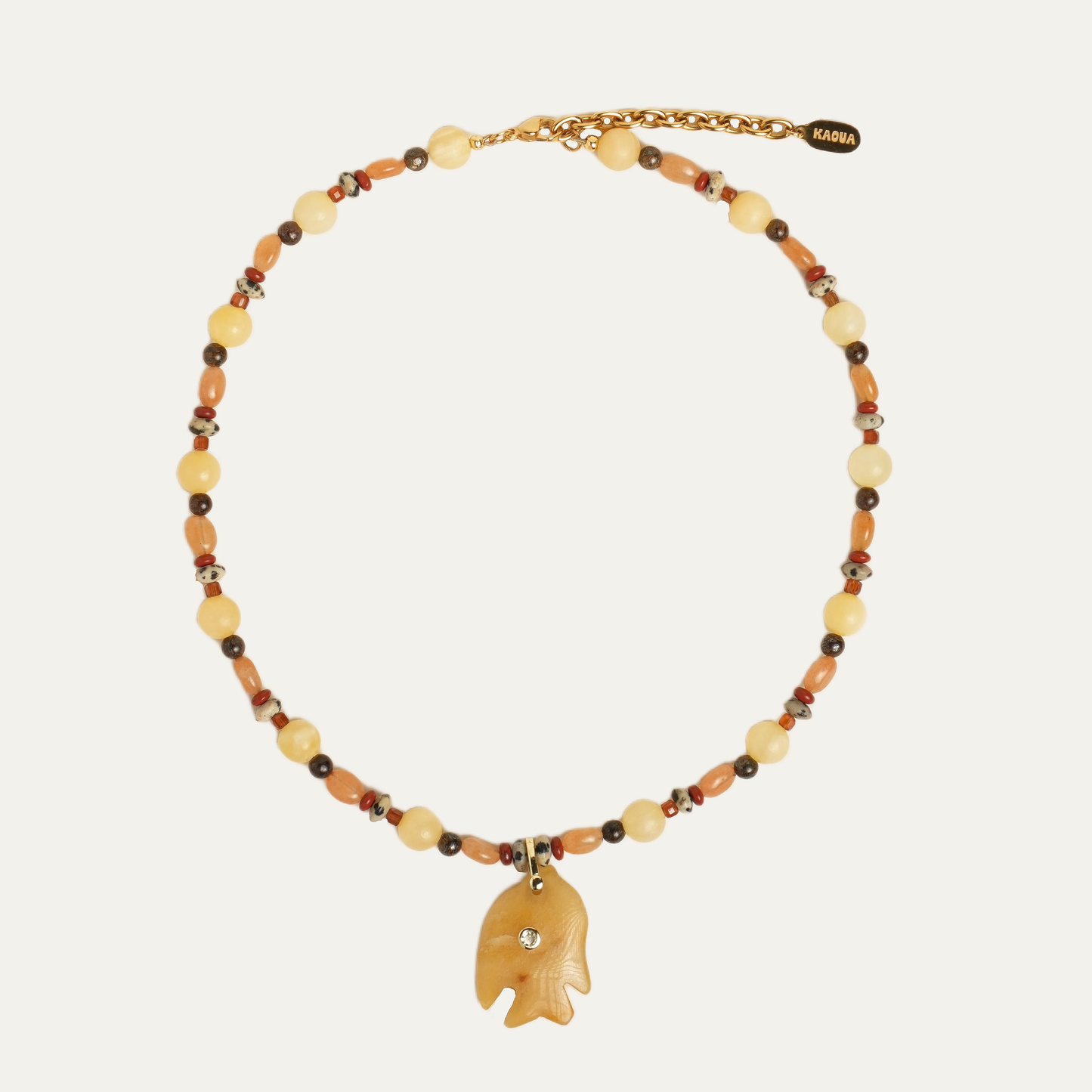 JUNO necklace from After-Sun Hours, honey and amber beaded strand with a carved fish pendant.