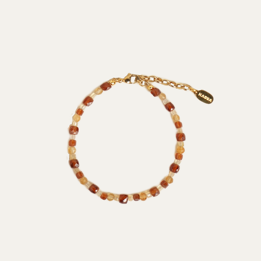 SUNA bracelet from After-Sun Hours, warm orange and pale yellow beads.