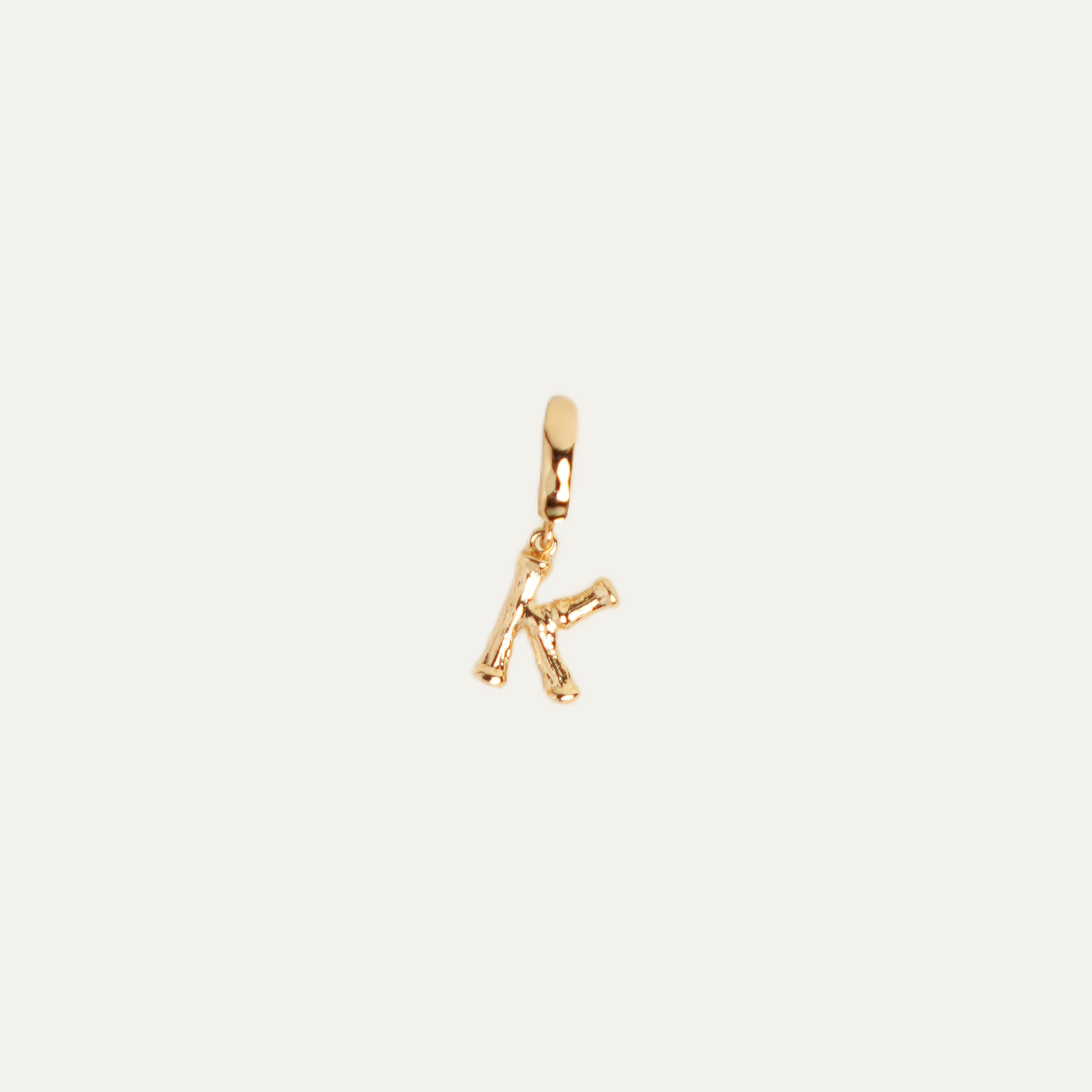 CABANA INITIALS charm from After-Sun Hours, gold-plated bamboo letter charm on a removable clasp.
